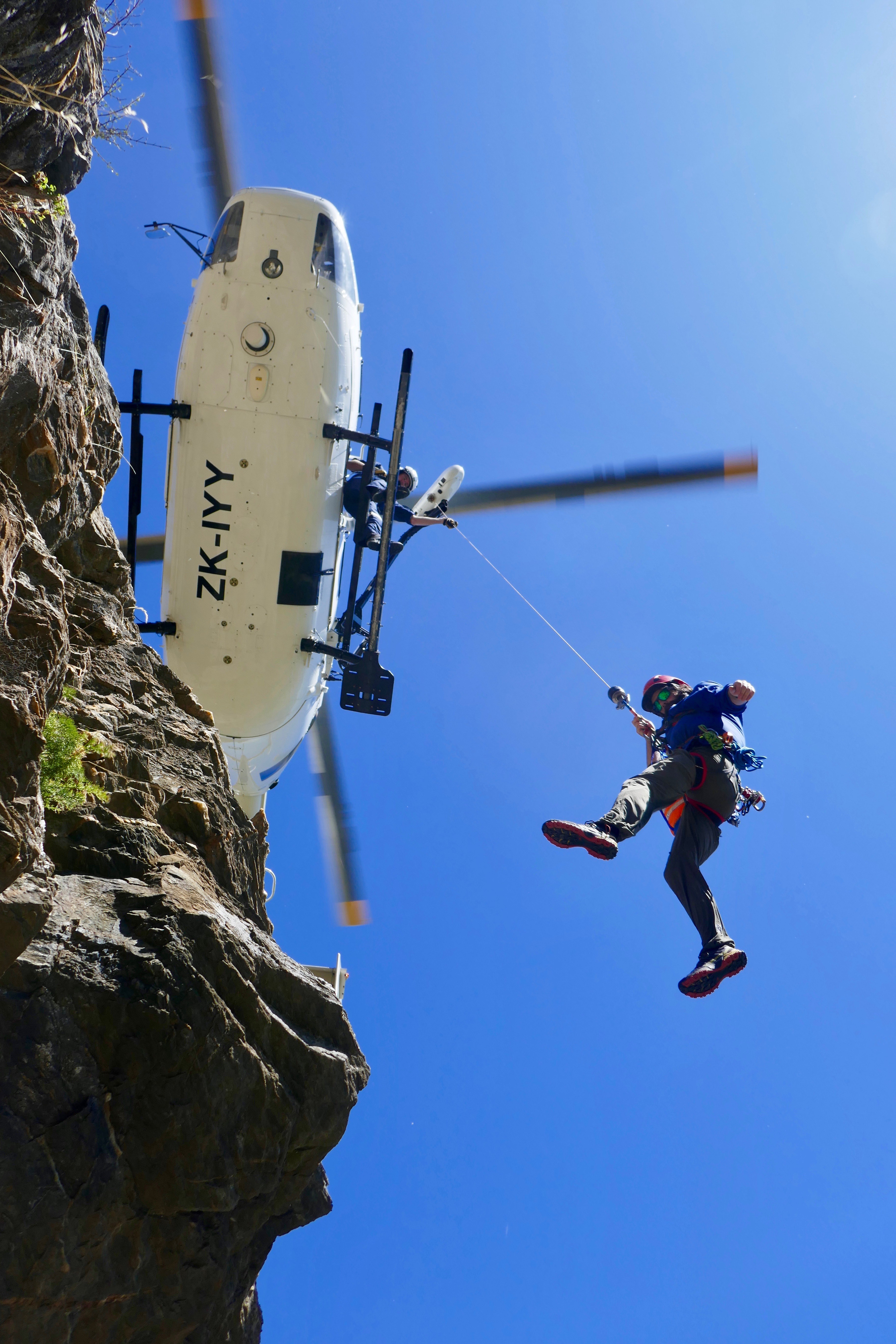 Niall Mclean on the winch line from the Southern Lakes Helicopters BK117, during winch training with Richie Hunter operating the winch during Queenstown Alpine Cliff Rescue training at Jacks Point in Queenstown